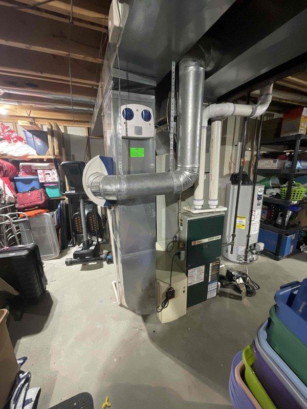 Conducted comprehensive assessment of existing HVAC system for full replacement estimate. Evaluated 20-year-old outdoor air conditioning unit positioned on concrete pad with existing refrigerant lines, electrical disconnect, and condensate drainage system. Inspected basement furnace installation including ductwork configuration, supply and return air distribution, and current system layout. Documented equipment conditions, existing infrastructure, and installation requirements for proposed furnace and air conditioner replacement with priority given to air conditioning system replacement.
