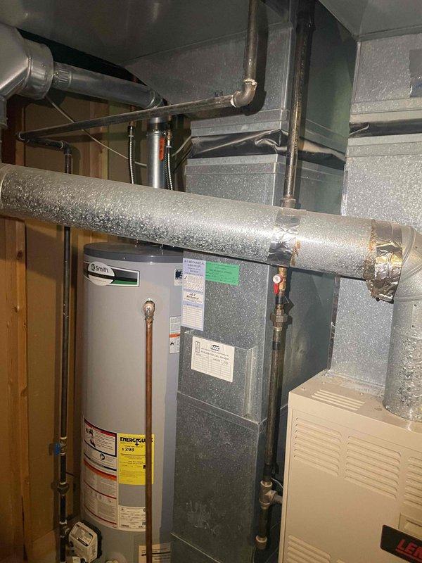 Conducted comprehensive evaluation of existing HVAC system for full replacement estimate. Assessed current air handler unit installed in utility closet and documented equipment configuration including ductwork connections, condensate drainage, and electrical components. Photographed existing mechanical installations to provide accurate system specifications for replacement proposal.