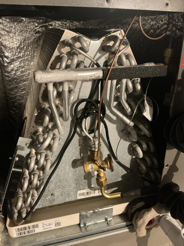 Completed scheduled air conditioning maintenance on Lennox split system. Performed comprehensive inspection of indoor evaporator coil assembly and outdoor condensing unit, documenting equipment condition through photography. Verified proper refrigerant line connections, checked service port accessibility, and confirmed all system components are operating within normal parameters for continued reliable cooling performance.