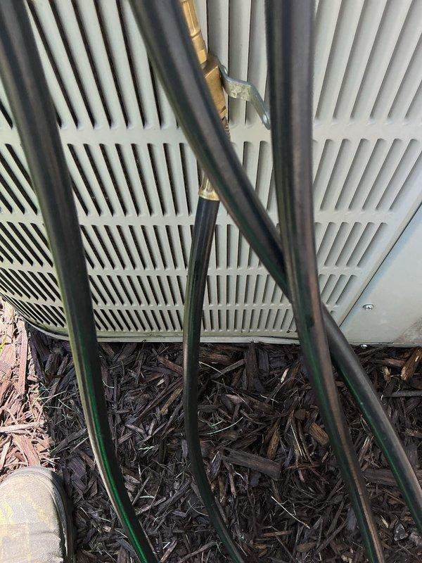 Completed annual air conditioning maintenance inspection. Connected manifold gauges to measure refrigerant pressures and verify system operating within manufacturer specifications. Inspected outdoor condenser unit, refrigerant line connections, and service valves for proper operation and secure fittings.