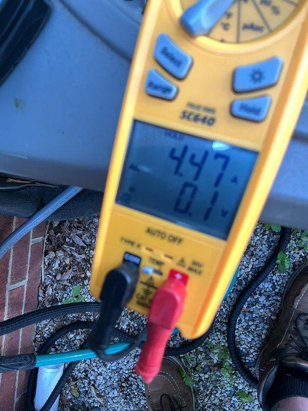 Completed routine preventative maintenance on five-year-old central air conditioning system. Performed comprehensive tune-up including electrical diagnostics using digital multimeter to verify proper voltage and amperage readings at outdoor condenser unit. System tested at 447V and 40.5A, confirming unit is operating within normal parameters. Inspected condenser coils, checked refrigerant levels, and verified all electrical connections are secure. Unit is functioning properly with no issues identified during service visit.