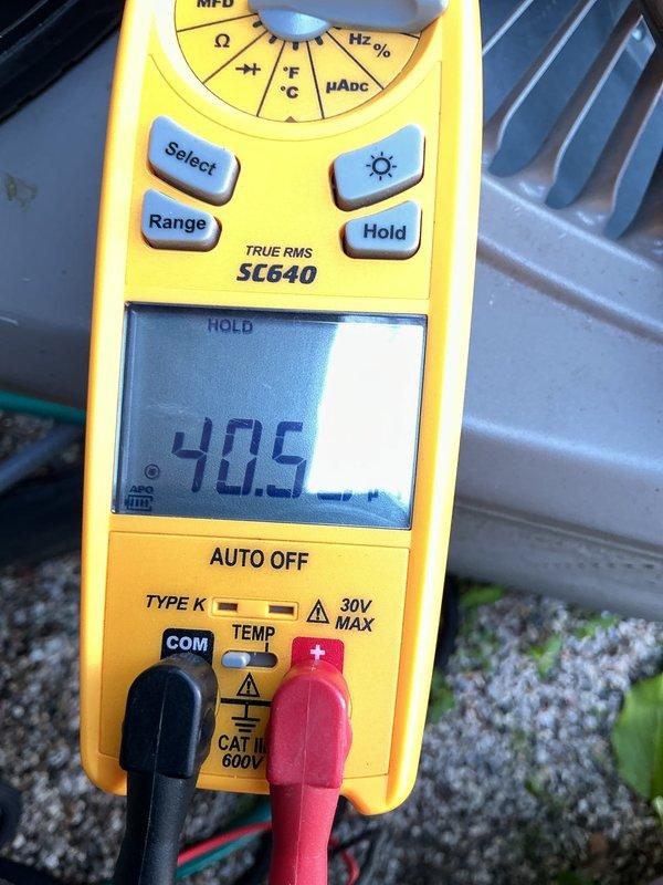 Completed routine preventative maintenance on five-year-old central air conditioning system. Performed comprehensive tune-up including electrical diagnostics using digital multimeter to verify proper voltage and amperage readings at outdoor condenser unit. System tested at 447V and 40.5A, confirming unit is operating within normal parameters. Inspected condenser coils, checked refrigerant levels, and verified all electrical connections are secure. Unit is functioning properly with no issues identified during service visit.