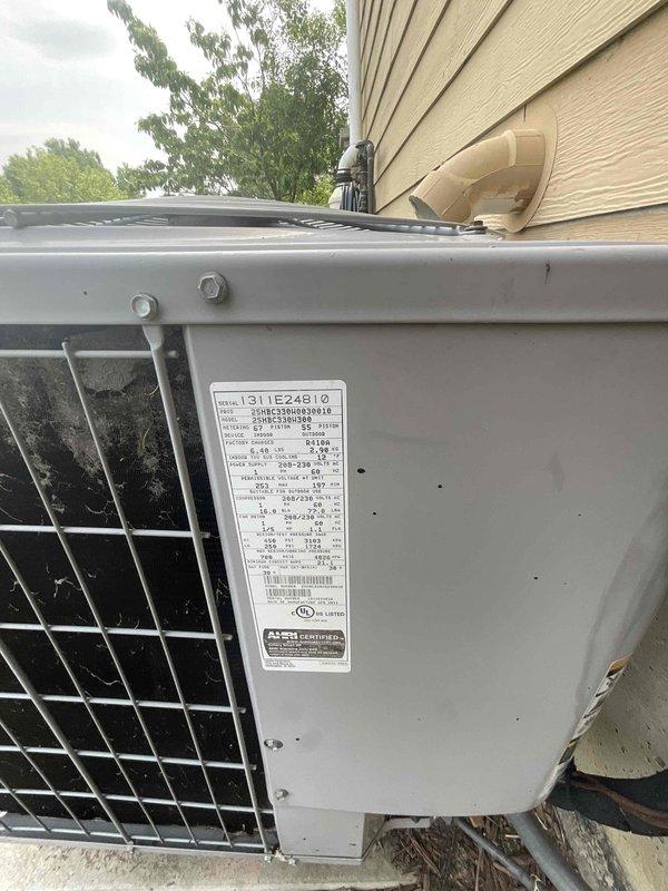 Conducted on-site assessment for complete air conditioning system replacement. Evaluated existing 15-year-old outdoor condensing unit positioned on concrete pad adjacent to building exterior, noting unit's age and operational history. Inspected indoor air handler located in basement mechanical room alongside existing water heater and ductwork infrastructure. Documented current system configuration including refrigerant line routing through exterior conduit, electrical connections, and existing ductwork distribution throughout the space. Photographed equipment specifications, model information, and installation conditions to prepare comprehensive replacement quote for new AC system installation scheduled within the month.