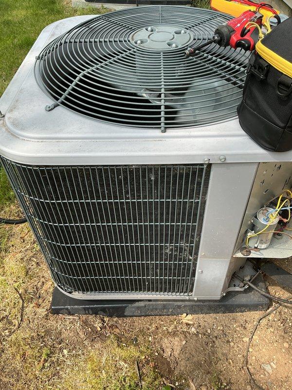 Completed annual cooling maintenance on residential split system air conditioning unit. Performed comprehensive system inspection of outdoor condenser unit and verified proper operation of compressor, fan motor, and electrical components. Checked refrigerant pressures and temperatures using manifold gauge set. Inspected copper refrigerant line connections and service valves for signs of leaks or damage. Noted accumulation of dirt and debris in condenser drain pan requiring attention during future service. All major components operating within normal parameters at time of inspection.