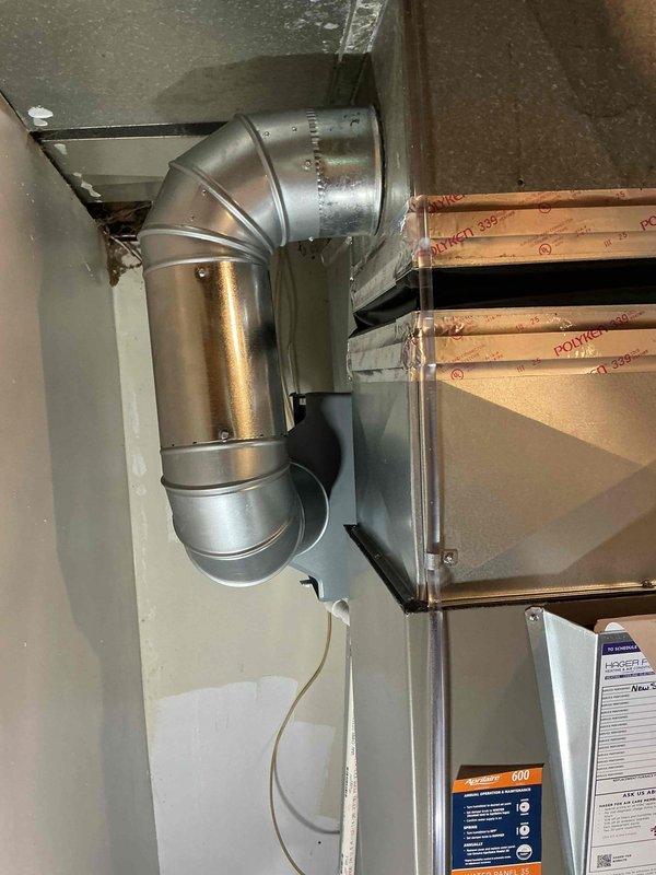 Completed full HVAC system installation including a 70,000 BTU furnace with humidifier and 2.5-ton air conditioning unit with rear discharge configuration. Installed new ductwork with galvanized metal components including 90-degree elbows and cylindrical sections in the mechanical room area. Positioned outdoor condensing unit on rubber pad against building exterior with proper drainage lines and electrical connections. Reconnected all necessary utilities and verified system operation upon completion.