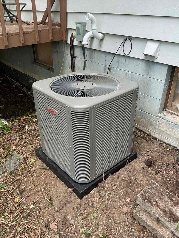Completed full HVAC system installation including a 70,000 BTU furnace with humidifier and 2.5-ton air conditioning unit with rear discharge configuration. Installed new ductwork with galvanized metal components including 90-degree elbows and cylindrical sections in the mechanical room area. Positioned outdoor condensing unit on rubber pad against building exterior with proper drainage lines and electrical connections. Reconnected all necessary utilities and verified system operation upon completion.
