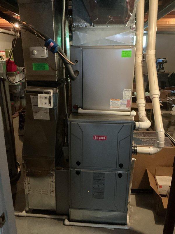 Completed annual cooling maintenance on Bryant HVAC system. Inspected evaporator coil and found heavy dust and debris accumulation throughout, particularly on the inlet side, which was restricting airflow and reducing system efficiency. Pulled and replaced air filter, inspected all accessible components including refrigerant lines, condensate drain system, and ductwork connections, and documented equipment condition with photographs for service records.