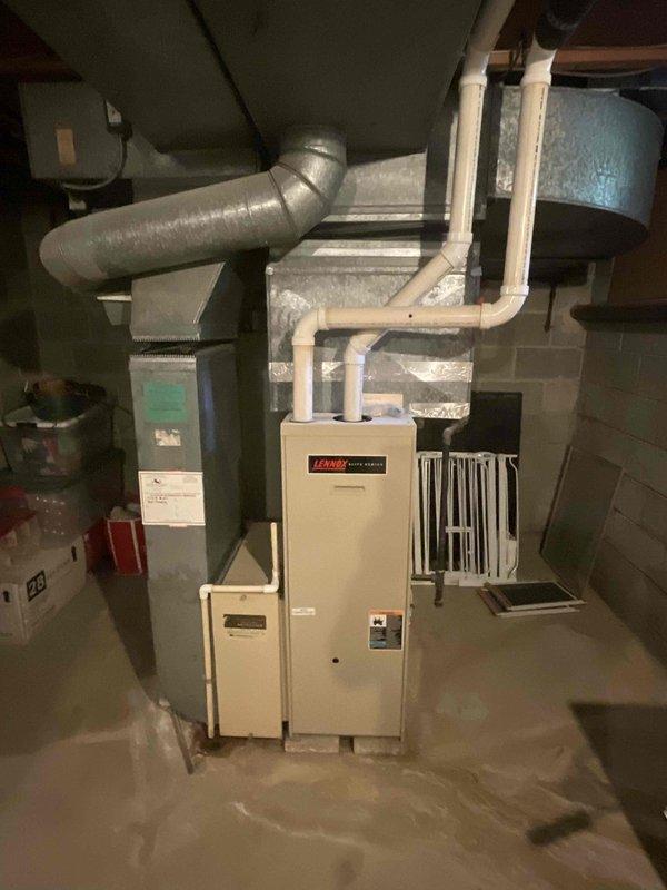 Responded to customer report of air conditioning system failure with complete loss of cooling throughout the home. Conducted comprehensive assessment of existing HVAC system, including evaluation of outdoor condensing unit and indoor air handling equipment. Documented existing Lennox furnace installation in basement mechanical room with associated ductwork configuration. Provided detailed replacement estimate for new air conditioning system to restore cooling capacity to the residence.