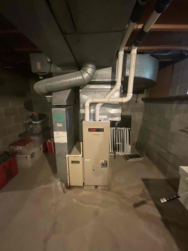Responded to customer report of air conditioning system failure with complete loss of cooling throughout the home. Conducted comprehensive assessment of existing HVAC system, including evaluation of outdoor condensing unit and indoor air handling equipment. Documented existing Lennox furnace installation in basement mechanical room with associated ductwork configuration. Provided detailed replacement estimate for new air conditioning system to restore cooling capacity to the residence.