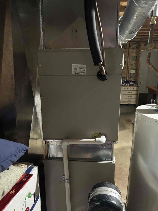 Responded to no cooling complaint on 14-year-old residential air conditioning system that had received 3 lbs of refrigerant charge from another contractor one month prior. Performed comprehensive diagnostic evaluation of outdoor condensing unit and indoor air handler to provide second opinion after previous company deemed system unrepairable. Conducted visual inspection of outdoor unit located beneath elevated deck, checked refrigerant pressures, tested compressor operation, inspected evaporator coil accessibility at furnace location, and evaluated overall system performance. Identified active refrigerant leak causing recurring loss of charge and inadequate cooling capacity. Assessed condition of aging components including compressor, coil integrity, and refrigerant line connections. Documented findings with photographic evidence of equipment placement and installation conditions. Provided customer with detailed explanation of diagnostic results, repair options, and professional recomm
