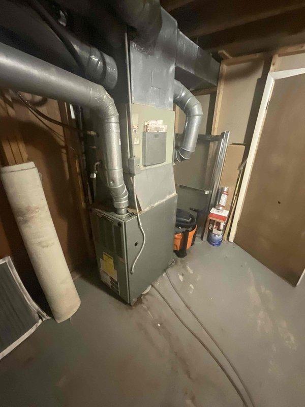 Conducted on-site evaluation for air conditioning system replacement. Existing 20-year-old outdoor condenser unit experiencing refrigerant leak, rendering system non-functional and uneconomical to repair due to age and refrigerant phase-out regulations. Inspected indoor furnace and ductwork configuration in basement mechanical room to determine compatibility requirements for new AC installation. Documented current equipment setup including outdoor condensing units on concrete pad and indoor air handler connections. Provided comprehensive replacement estimate for new energy-efficient air conditioning system with expedited installation timeline as requested.