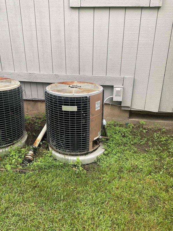Conducted on-site evaluation for air conditioning system replacement. Existing 20-year-old outdoor condenser unit experiencing refrigerant leak, rendering system non-functional and uneconomical to repair due to age and refrigerant phase-out regulations. Inspected indoor furnace and ductwork configuration in basement mechanical room to determine compatibility requirements for new AC installation. Documented current equipment setup including outdoor condensing units on concrete pad and indoor air handler connections. Provided comprehensive replacement estimate for new energy-efficient air conditioning system with expedited installation timeline as requested.