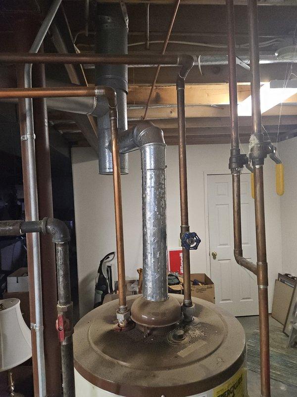 Completed annual cooling maintenance inspection on HVAC system. Performed comprehensive evaluation of mechanical equipment in utility area, documented water heater installation and associated plumbing connections, and verified proper operation of all heating and cooling components during scheduled maintenance visit.