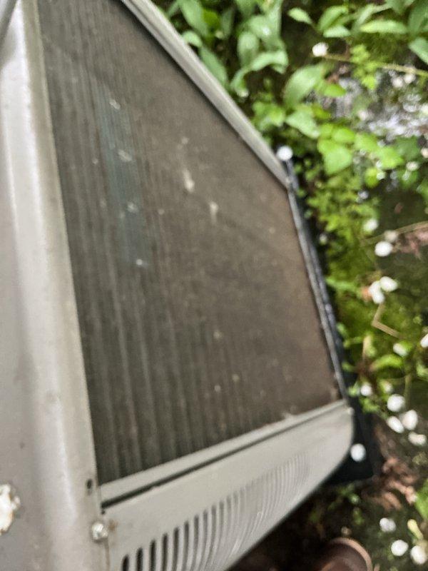 Completed scheduled ACM maintenance on residential air conditioning unit, including inspection of condenser coils which showed accumulated debris and dust on mesh screening and metal fins. Performed system diagnostics with multimeter, recording voltage and amperage readings to verify proper electrical operation and compressor function.