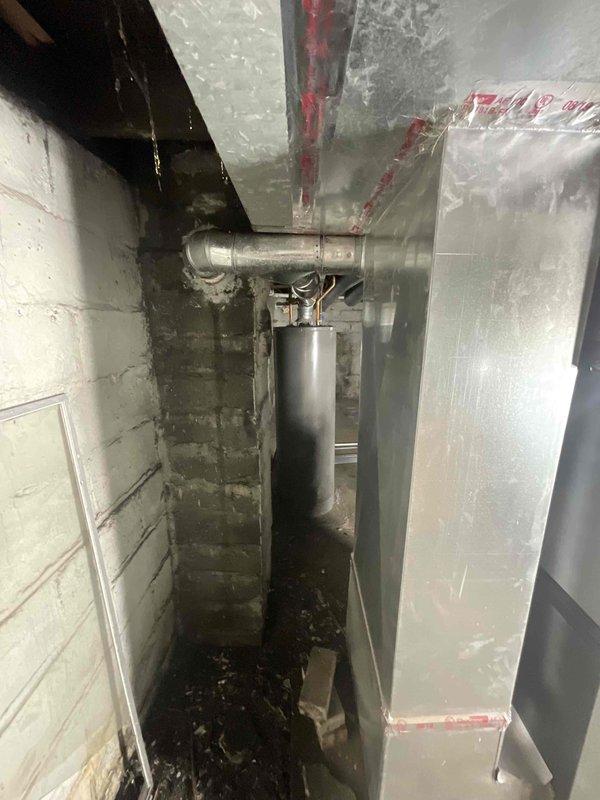 Provided estimate for complete replacement of non-operational furnace and hot water heater located in basement mechanical room. Both units are inoperable with unknown age, showing signs of extended service life in moisture-compromised environment with visible water damage and deterioration on surrounding concrete block walls. Assessed existing HVAC infrastructure including ductwork, venting systems, and utility connections to determine replacement requirements and proper equipment sizing for residential heating and domestic hot water needs.