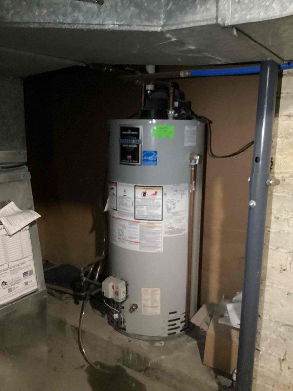 Completed full HVAC system installation including outdoor condensing unit and indoor water heater. Installed new air conditioning unit on concrete pad with proper refrigerant line connections, electrical disconnect, and PVC condensate drainage. Mounted all associated piping and electrical components to exterior wall per code requirements. Inside utility area, installed new cylindrical water heater with copper plumbing connections, blue PEX water supply lines, and proper venting system. Documented installation with photographs of all new equipment. Retrieved previously left equipment from property. Discussed inadequate return air situation with homeowner and provided recommendations for system optimization.