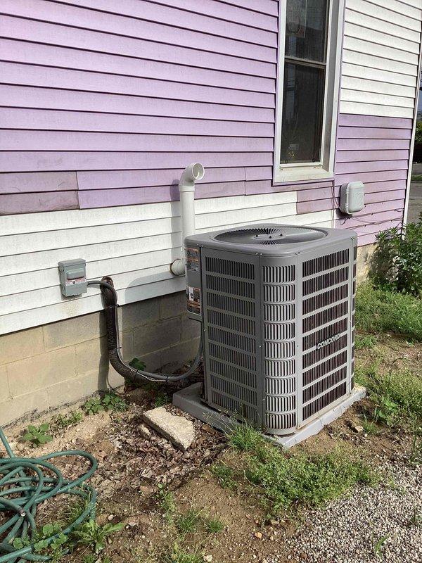 Completed full HVAC system installation including outdoor condensing unit and indoor water heater. Installed new air conditioning unit on concrete pad with proper refrigerant line connections, electrical disconnect, and PVC condensate drainage. Mounted all associated piping and electrical components to exterior wall per code requirements. Inside utility area, installed new cylindrical water heater with copper plumbing connections, blue PEX water supply lines, and proper venting system. Documented installation with photographs of all new equipment. Retrieved previously left equipment from property. Discussed inadequate return air situation with homeowner and provided recommendations for system optimization.