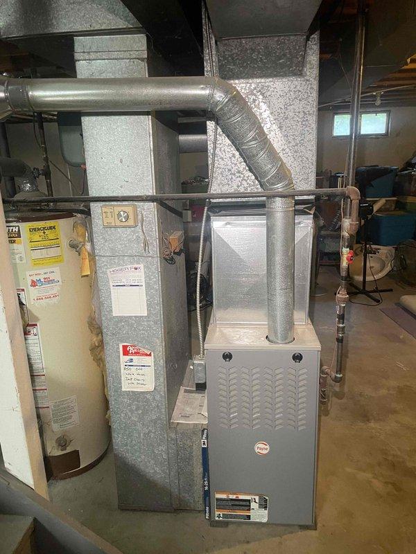 Conducted on-site evaluation for first-time central air conditioning installation at residential property with no existing AC system. Assessed basement mechanical room containing gas furnace with existing ductwork infrastructure and water heater to determine feasibility and requirements for adding cooling system. Documented existing HVAC equipment configuration, available space for outdoor condensing unit placement, electrical service capacity, and ductwork compatibility for integration of new air conditioning components.