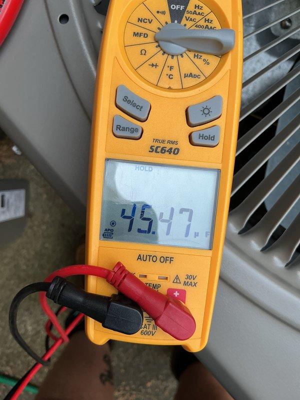 Completed comprehensive AC tune-up and maintenance on 10-year-old system. Performed electrical diagnostics using multimeter, recording voltage readings of 596V and 0.2V at outdoor unit, along with capacitance measurement of 45.47 MFD to verify proper component operation. System inspected and found operating within normal parameters with no deficiencies noted.