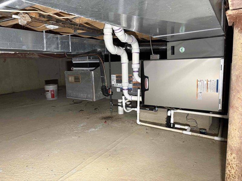 Completed full HVAC system installation in basement consisting of a 90,000 BTU furnace and 3-ton air conditioning unit configured for right-side placement. Installed complete ductwork system including rigid rectangular metal ducts and flexible insulated ducting with proper connections to air handler. Ran white PVC venting pipes from furnace with appropriate joints and purple primer application, routing pipes vertically and horizontally for proper exhaust. Connected humidifier to system and completed all necessary electrical wiring along ceiling joists. Reconnected all components to existing infrastructure and verified proper drainage with condensate lines. All mechanical permits obtained prior to installation and system positioned according to specifications in residential basement space with exposed joists.