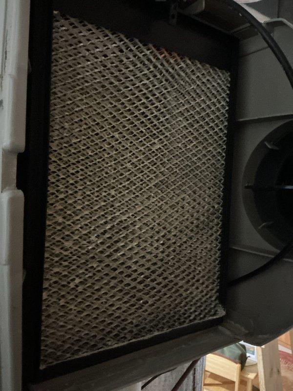 Performed comprehensive seasonal air conditioning maintenance on a five-year-old system with no reported cooling issues. Conducted complete system inspection including examination of refrigerant lines, evaporator coil, blower assembly, and all accessible HVAC components. Inspected humidifier pad which showed typical mineral deposits and discoloration consistent with normal operation. Verified all copper refrigerant lines, brass fittings, and connections for proper condition and secure mounting. Checked condensate drainage system including PVC drain lines for proper flow and blockage prevention. Examined blower motor housing and fan assembly for proper operation. Inspected all electrical connections, wiring, and control components within the unit. Verified system labeling and technical specifications on equipment panels. Documented system condition through photographic records of internal components including evaporator section, refrigerant piping with barcode identification, and humidi