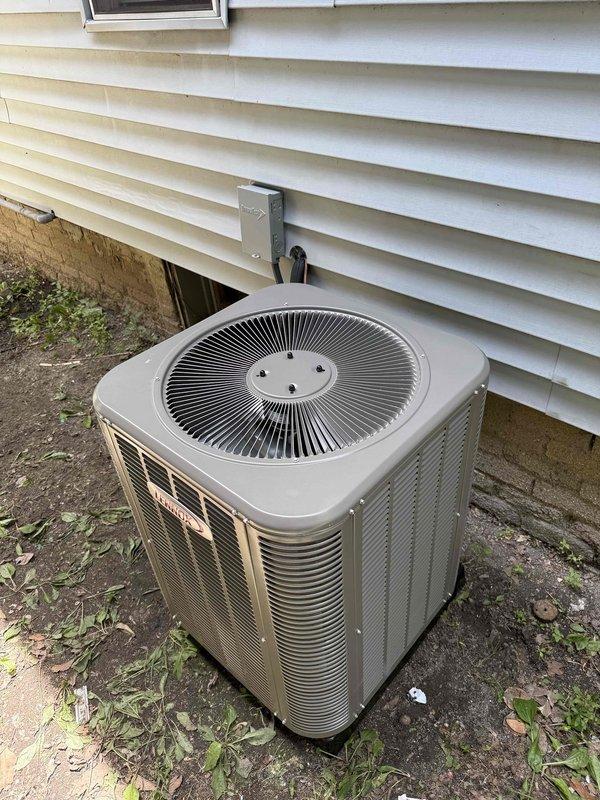 Completed full HVAC system installation including a 70,000 BTU furnace and 2-ton air conditioning unit. Furnace was installed in basement utility area on condensate pan with proper PVC venting and drainage systems, including condensate pump installation. AC condenser unit was positioned on concrete pad on right side of residence with electrical disconnect and proper refrigerant line connections. All necessary mechanical permits were obtained prior to installation, and system was fully reconnected and commissioned for operation.