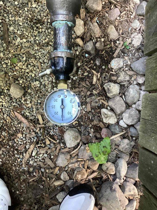 Performed pressure test on generator gas line installation using calibrated pressure gauge assembly. Connected test gauge to piping system with appropriate fittings and clamps, verified system integrity and proper pressure readings per manufacturer specifications. Documented test results with photographic evidence showing gauge readings and connection points for service records.