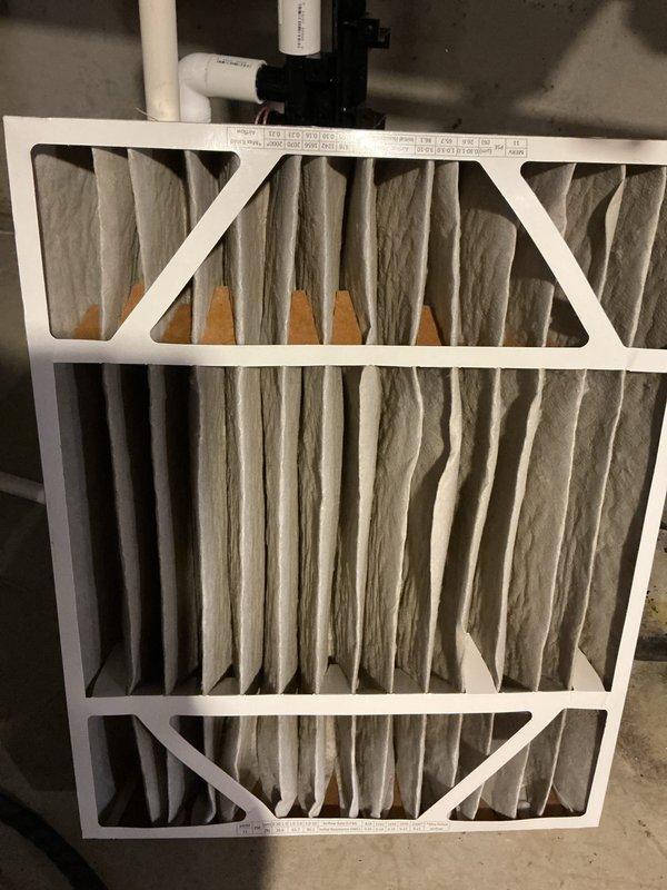 Completed annual cooling maintenance inspection on HVAC system. Identified and documented heavily soiled mesh filter with significant dust and debris accumulation requiring replacement. Installed new HCF20-11 MERV 11 pleated air filter to restore proper airflow and system efficiency.