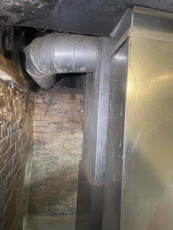 Conducted on-site assessment for ductless mini split cooling system installation in residence with no existing cooling equipment. Evaluated interior living space with existing thermostat location and inspected basement mechanical room containing exposed ductwork, aged brick walls, and existing HVAC cabinet to determine optimal placement for indoor and outdoor units and establish routing for refrigerant lines and electrical connections.