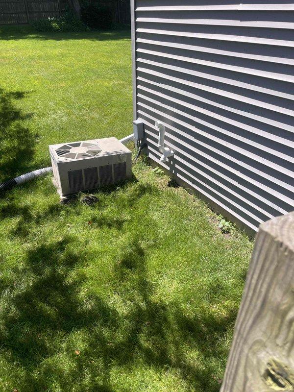Conducted comprehensive assessment of 16-year-old residential air conditioning system for full replacement estimate. Evaluated outdoor condenser unit positioned on exterior pad, inspected refrigerant line routing along building wall, and assessed indoor HVAC equipment and ductwork configuration in basement mechanical space. Documented existing system conditions through photographic evidence and provided detailed replacement recommendations to homeowner seeking equipment upgrade within current season.