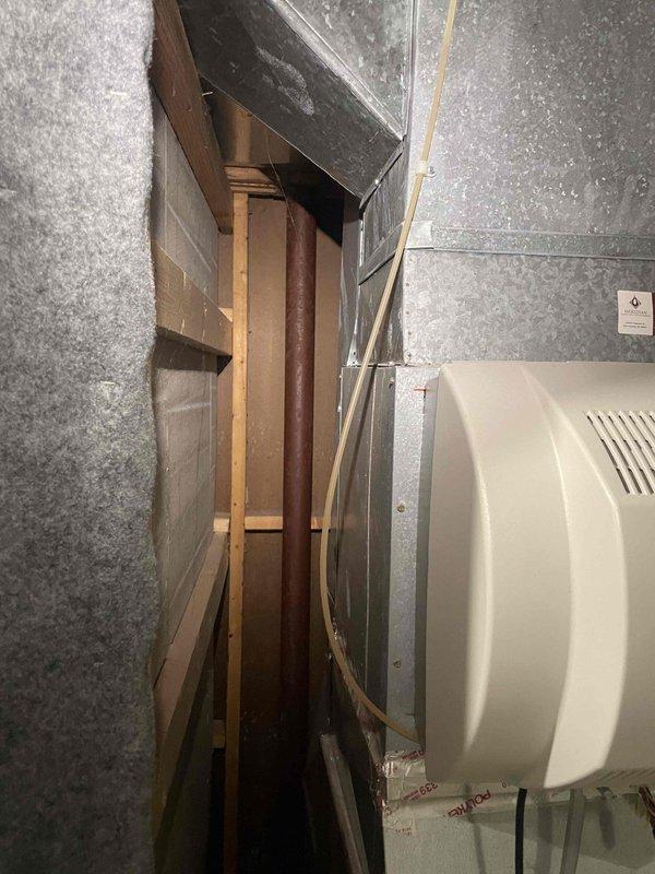 Conducted comprehensive assessment of 16-year-old residential air conditioning system for full replacement estimate. Evaluated outdoor condenser unit positioned on exterior pad, inspected refrigerant line routing along building wall, and assessed indoor HVAC equipment and ductwork configuration in basement mechanical space. Documented existing system conditions through photographic evidence and provided detailed replacement recommendations to homeowner seeking equipment upgrade within current season.