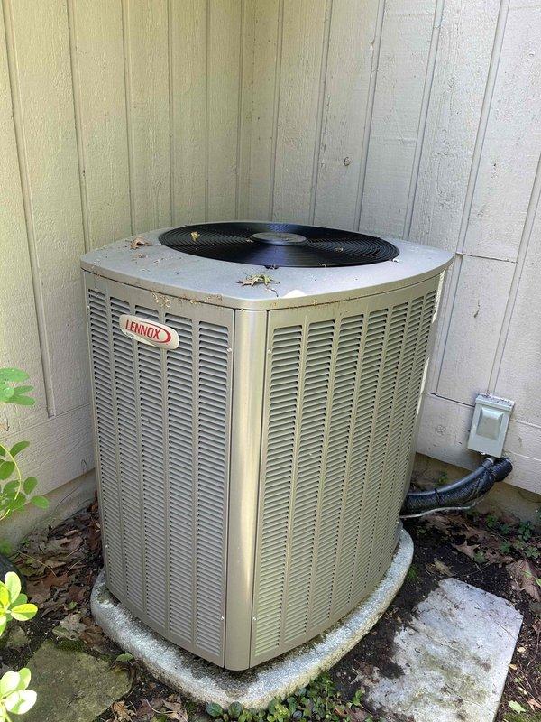 Responded to callback for Lennox air conditioning system displaying "service urgent" message on thermostat with unit not operating. Upon arrival, inspected 5-year-old outdoor condenser unit and accessed control board compartment. Diagnosed control board issue related to safety lockout condition. Inspected dual circuit board assembly including upper control board with integrated circuits and wiring harness connections, and lower board containing toroidal inductors. Cleared fault code, verified all wire connections at terminal blocks were secure, and tested system operation. Unit restored to normal cooling operation with thermostat error message cleared and all safety controls functioning properly.