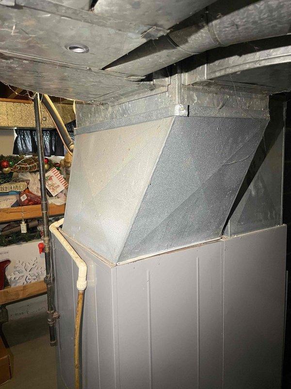 Conducted comprehensive HVAC system evaluation for non-operational furnace and air conditioning system in residential bungalow with forced air distribution and natural gas heating. Assessed existing basement-installed equipment, electrical panel configuration showing Cutler-Hammer load center with proper circuit distribution, and inspected ductwork plenum assembly including main supply trunk and distribution system. Documented current system conditions through photographic evidence of electrical service panel and existing HVAC ductwork installation to support full system replacement estimate for homeowner consideration.