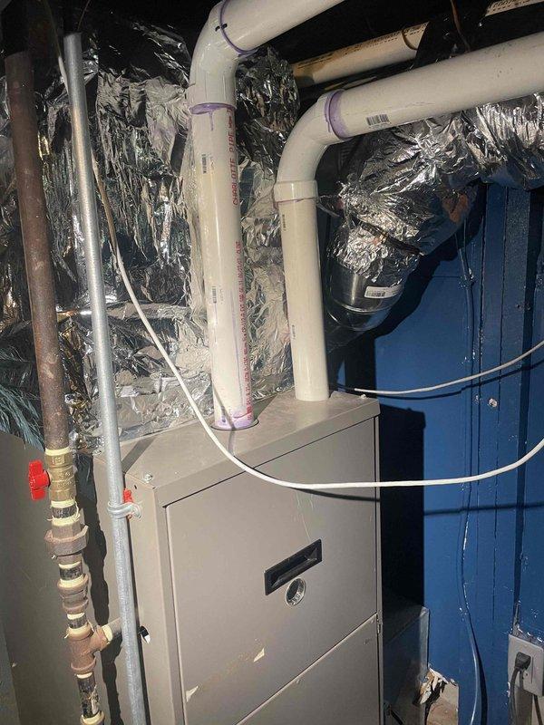 Provided estimate for air conditioning system installation at property currently without central A/C, utilizing window units. Existing forced air furnace located in basement with operational ductwork in place. Assessed site conditions and presented two cooling solutions: traditional central air conditioning system to integrate with existing forced air infrastructure, and ductless mini-split system to allow independent temperature control in different zones. Customer requested dual-zone capability to accommodate varying comfort preferences between bedroom and living areas.