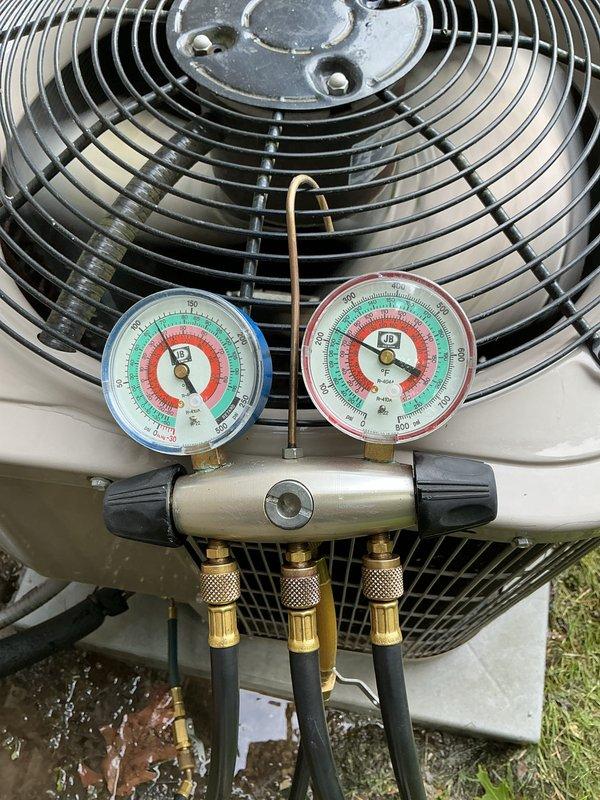 Completed annual cooling maintenance on residential air conditioning condenser unit. Connected manifold gauge set to measure refrigerant pressures and verify system operating parameters within manufacturer specifications. Inspected condenser coil, fan motor assembly, electrical connections, and refrigerant lines for proper operation and condition. Unit found to be functioning properly with no deficiencies noted at time of service.