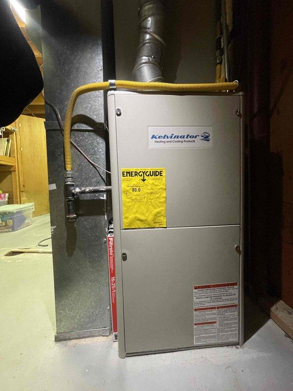 Conducted comprehensive evaluation of existing HVAC system for full replacement estimate. Inspected 15-year-old Kelvinator 2 furnace with 80.0 AFUE rating and 10-year-old air conditioning system located in basement utility area. Assessed condition of gas supply line, ductwork connections, and ventilation system. Documented crystalline mineral buildup on vertical supply duct indicating potential condensation or humidity issues. Evaluated installation space, existing infrastructure including concrete floor placement, and accessibility for equipment replacement. Provided estimates for replacement furnace, air conditioning unit, and optional water heater replacement to meet customer's timeline of replacement within one month.