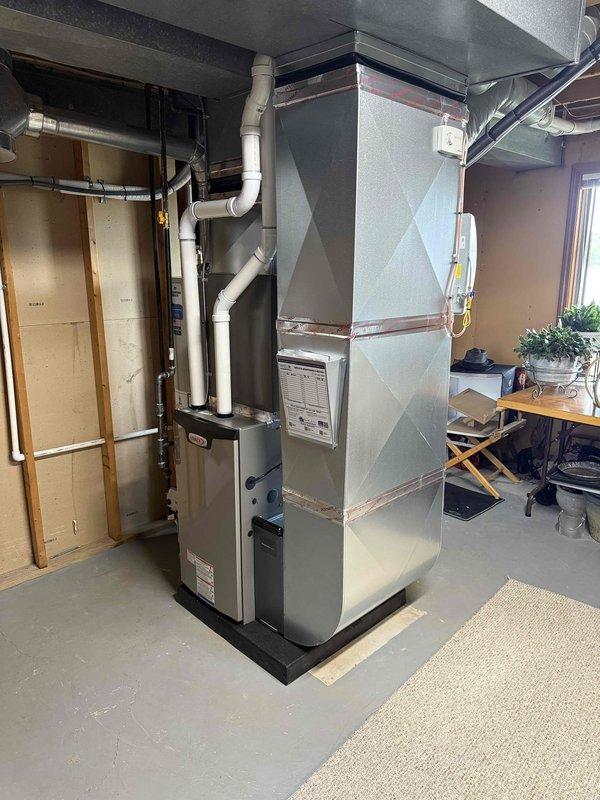 Completed full HVAC system installation in basement utility area, including 70,000 BTU gas furnace and 2.5 ton air conditioning unit with rear discharge configuration. Installed new ductwork assembly, humidifier integration, and PVC condensate drainage system. All mechanical connections, electrical hookups, and refrigerant lines were completed and tested for proper operation.