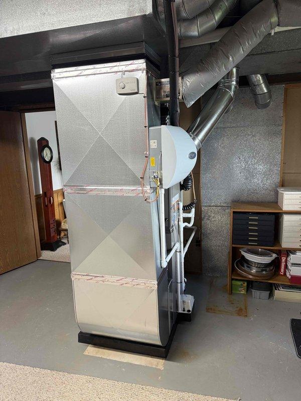 Completed full HVAC system installation in basement utility area, including 70,000 BTU gas furnace and 2.5 ton air conditioning unit with rear discharge configuration. Installed new ductwork assembly, humidifier integration, and PVC condensate drainage system. All mechanical connections, electrical hookups, and refrigerant lines were completed and tested for proper operation.
