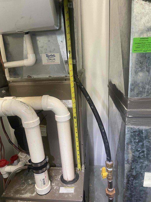 Conducted full system evaluation on 15-year-old residential air conditioning system experiencing complete failure. Inspection revealed severely frozen evaporator coil with extensive ice buildup throughout the air handler unit, confirming suspected refrigerant leak that was temporarily repaired two years prior. System has lost refrigerant charge again, rendering unit inoperative. Documented measurements and photographed evaporator coil condition, PVC condensate drainage system, ductwork connections, and overall mechanical room configuration. Assessed all system components including air handler, refrigerant lines, condensate management, and gas connections. Based on age of equipment, recurring refrigerant leak in evaporator coil, and customer's immediate need for reliable cooling, provided comprehensive estimate for complete HVAC system replacement rather than additional temporary repairs to aging equipment.