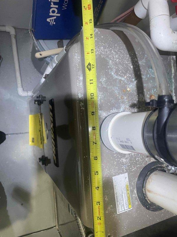 Conducted full system evaluation on 15-year-old residential air conditioning system experiencing complete failure. Inspection revealed severely frozen evaporator coil with extensive ice buildup throughout the air handler unit, confirming suspected refrigerant leak that was temporarily repaired two years prior. System has lost refrigerant charge again, rendering unit inoperative. Documented measurements and photographed evaporator coil condition, PVC condensate drainage system, ductwork connections, and overall mechanical room configuration. Assessed all system components including air handler, refrigerant lines, condensate management, and gas connections. Based on age of equipment, recurring refrigerant leak in evaporator coil, and customer's immediate need for reliable cooling, provided comprehensive estimate for complete HVAC system replacement rather than additional temporary repairs to aging equipment.
