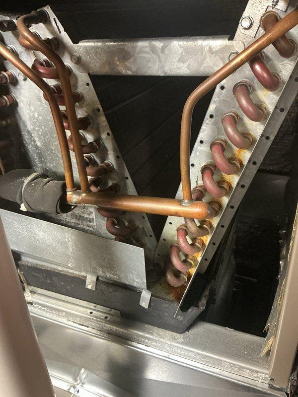 Completed annual cooling maintenance on Lennox HVAC system. Inspected evaporator coil assembly, verified copper refrigerant lines and U-bend connections are secure and free of corrosion, checked condensate drain pan for proper operation, and examined aluminum fin condition. All components functioning within normal parameters; unit operational and ready for cooling season.