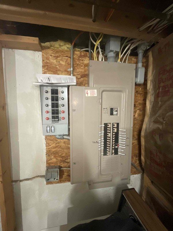 Completed new whole home generator installation for manufactured home. Installed generator transfer switch and integrated with existing main electrical panel, mounting both units on OSB backing in interior utility space with proper conduit and wiring connections. Identified suitable exterior generator placement location beneath structure with accessible utility connections including existing PVC and conduit infrastructure.