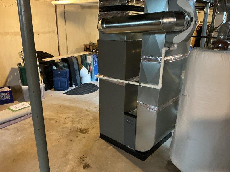 Completed full HVAC system installation in basement mechanical room, including 70,000 BTU gas furnace with left-side configuration and 2-ton air conditioning unit. Installed humidifier, connected all ductwork with metallic flex ducting, and reconnected existing electrical and gas lines. All permits obtained prior to installation, system tested and verified operational upon completion.