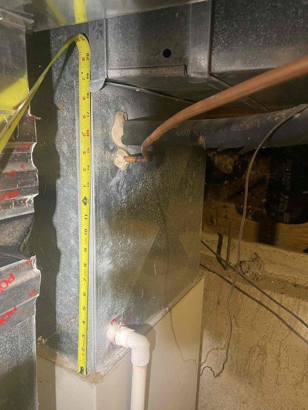 Conducted on-site evaluation of existing 20-year-old air conditioning system for replacement estimate. Assessed current HVAC equipment including air handler unit, refrigerant lines, and condensate drainage system in mechanical room. Performed dimensional measurements of existing equipment and available space to determine proper sizing requirements for new system installation. Documented current system configuration including PVC condensate piping, copper refrigerant lines, and ductwork connections. Evaluated installation constraints within confined utility space and identified necessary modifications for equipment replacement. Provided comprehensive replacement recommendations to meet homeowner's 10-day installation timeline requirement.