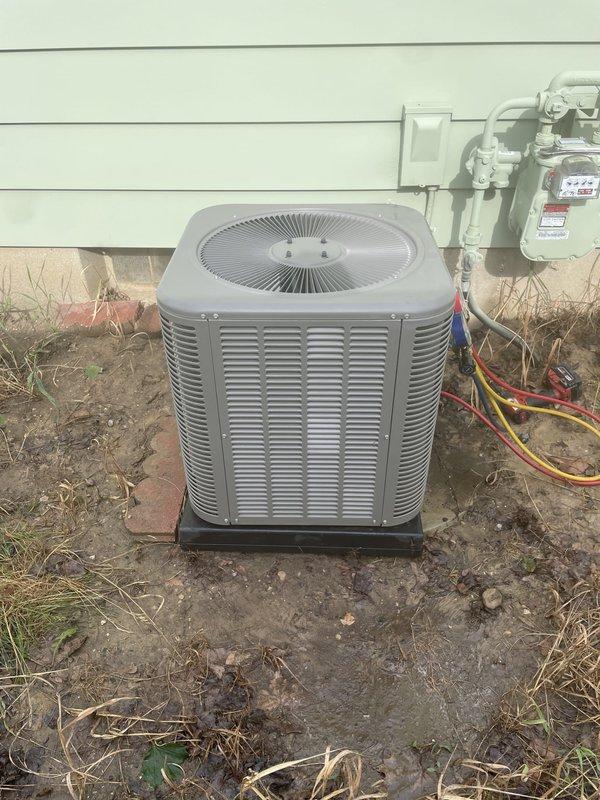 Completed annual cooling maintenance on Lennox outdoor condensing unit. Performed comprehensive system inspection including electrical connections, refrigerant line assessment, and condenser coil evaluation. Unit found operating within normal parameters. Verified proper placement on pad and confirmed all refrigerant lines and electrical connections secure. Documented equipment condition with photos showing unit positioned on black composite pad against building exterior with copper refrigerant lines properly routed to structure.