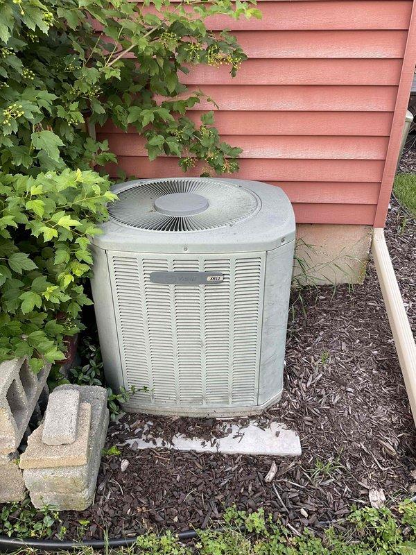 Performed on-site evaluation and provided replacement estimate for 18-year-old furnace and air conditioning system. Assessed existing indoor air handler unit with vertical duct configuration in mechanical closet and outdoor condenser unit positioned on concrete pad against exterior wall. Both units operating without current malfunctions but nearing end of expected service life, prompting homeowner to request replacement quotation for upgraded HVAC equipment.
