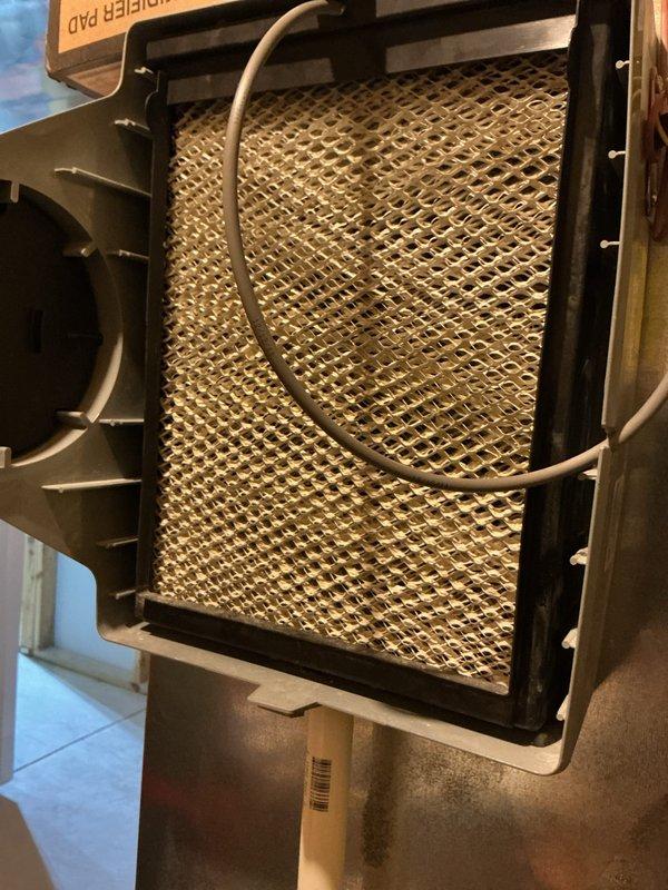 Completed scheduled air conditioning maintenance on ACM unit 6/1710-2. Inspected return air grille showing normal condensation buildup, verified proper airflow through slats and filter screen. Examined evaporator coil assembly, checked refrigerant lines and condensate drain tube for proper routing and connections, confirmed mesh filter condition with typical dust accumulation. All components operating within normal parameters, unit functional and ready for continued service.