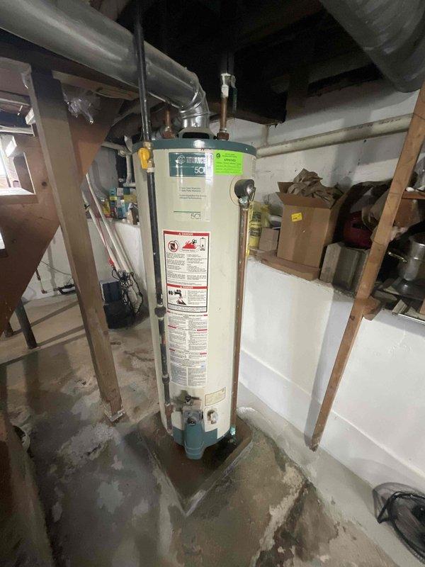 Responded to service call for air conditioning system with reported performance concerns. Upon arrival, performed comprehensive system evaluation of 6-year-old AC unit and furnace installation. Conducted thorough inspection of basement mechanical room, examining furnace cabinet, ductwork connections, and overall HVAC infrastructure. Assessed water heater proximity and clearances to mechanical equipment. Evaluated supply and return air duct configuration, including wrapped insulation integrity. Inspected furnace mounting, support straps, and structural installation. Reviewed system age, condition, and operational parameters. Presented full system replacement estimate to address performance concerns and aging equipment. Documented existing equipment configuration with photographic records of current mechanical room layout, furnace positioning, ductwork routing, and utility connections for replacement planning purposes.