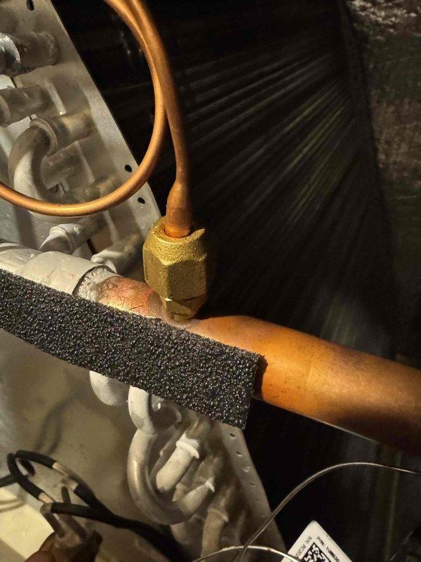 Responded to warranty service call for 11-month-old A/C system shutting off intermittently. Inspected refrigeration lines, connections, and evaporator coil in mechanical equipment area. Verified system pressures using digital refrigeration gauge, reading 238.9 PSI, and checked for proper refrigerant charge and potential restrictions. Examined copper line insulation integrity and brass fittings for leaks or loose connections. System operational at time of departure with no freezing conditions observed.
