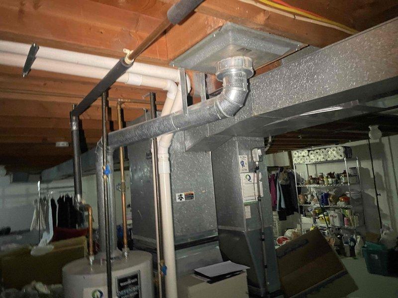 Completed on-site evaluation for full HVAC system replacement estimate. Assessed existing 22-year-old gas furnace and 30-year-old central air conditioning system in basement utility area. Documented current equipment configuration including ductwork layout, electrical connections, condensate drainage system, and outdoor condenser unit placement. Photographed existing installations to determine proper sizing and compatibility requirements for replacement equipment recommendations.
